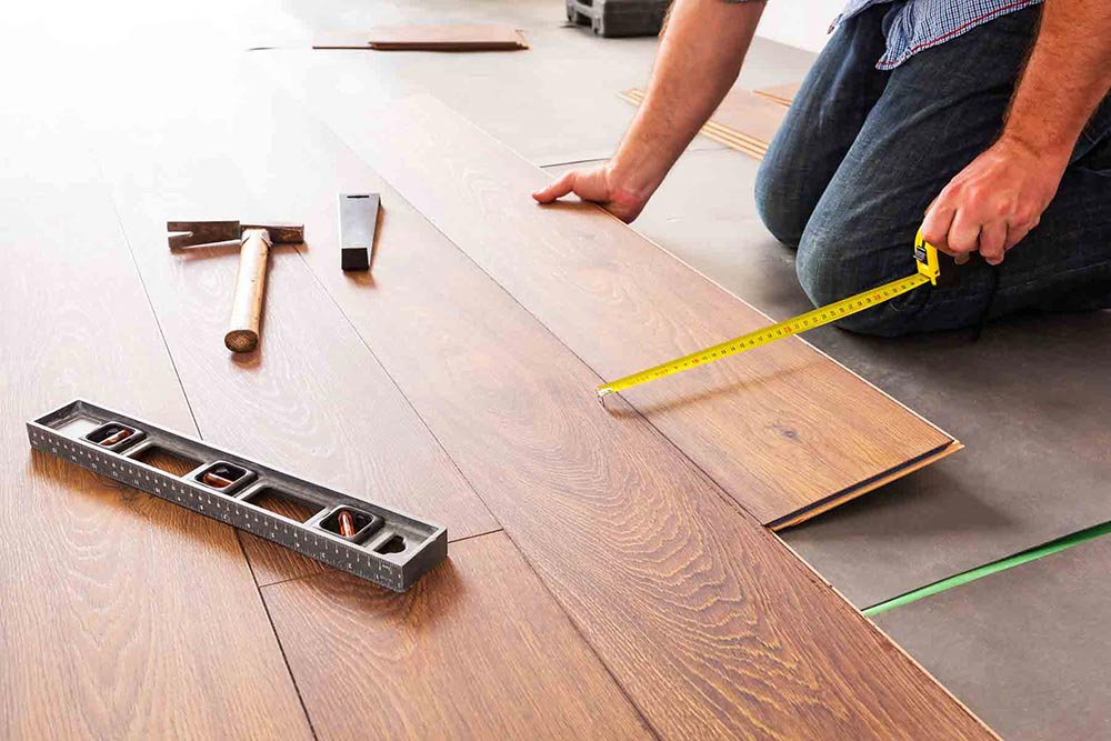 Installing laminate flooring.